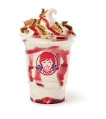 A Wendy’s Vanilla-Covered Strawberry Frosty with creamy vanilla flavor topped with sweet strawberry sauce