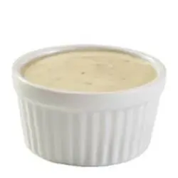 Creamy Caesar salad dressing with a rich, savory flavor.