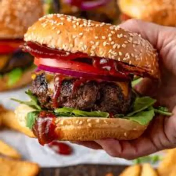 Close-up of Wendy’s smoky Barbecue Cheeseburger with crispy onions and cheddar cheese.