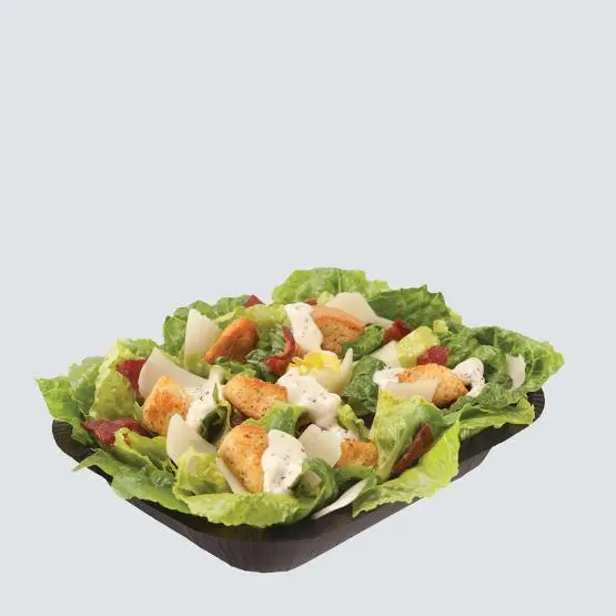 Caesar Side Salad with fresh romaine lettuce, shredded parmesan cheese, croutons, and creamy Caesar dressing