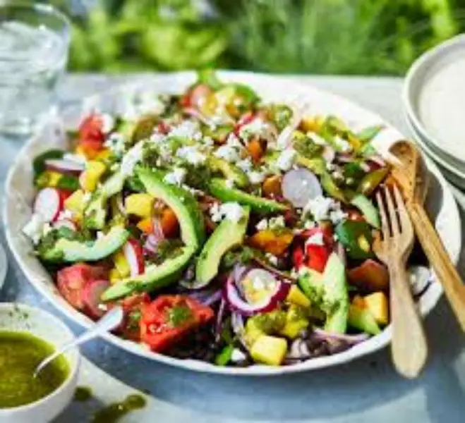 Healthy Fresh Salads with colorful vegetables, greens, and dressing served in a bowl