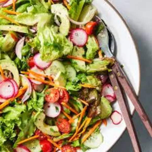 Fresh Garden Side Salad with crisp greens, tomatoes, and shredded cheese in a bowl.
